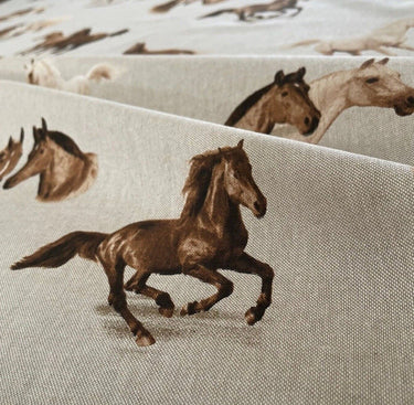 Close-up view of detailed galloping horse print on linen-look cotton fabric